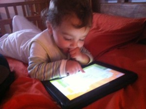 Leo playing with iPad, age 18 months